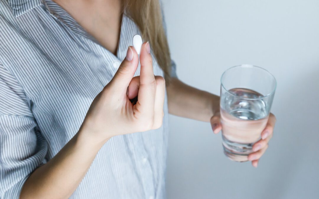 woman taking pill