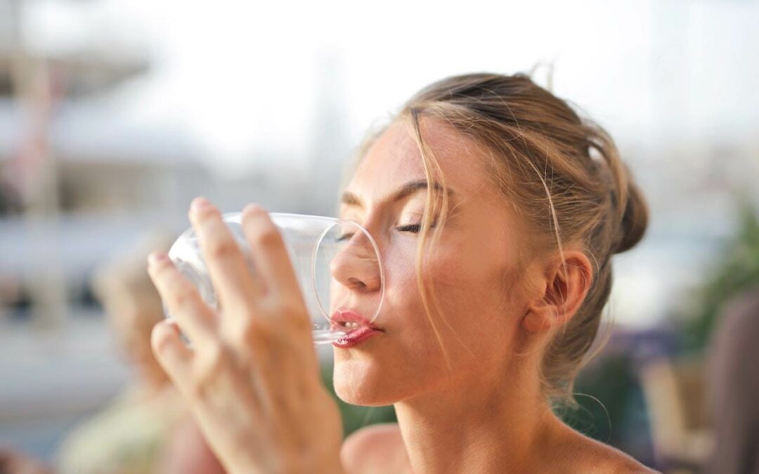 woman drinking a glass of water