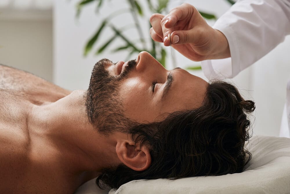acutrigger-male-patient Male patient laying down during acupuncture and acutrigger therapy.